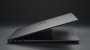 Sleek aluminum laptop with thin bezels and premium matte finish, photographed at 45-degree angle showing side profile and keyboard deck in professional lighting