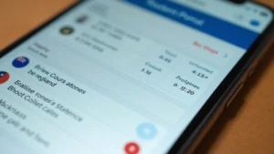 Close-up of smartphone displaying student portal dashboard with grade information, course schedule, and notification badges, modern minimalist design, shallow depth of field