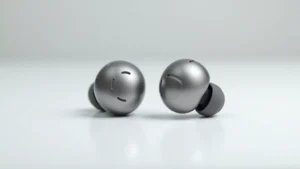 Sleek metallic wireless earbuds with minimalist design on white surface, professional product photography with soft lighting