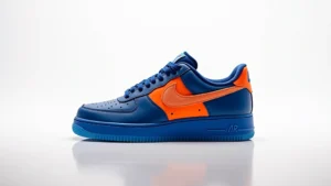 Professional product photography of customized Nike Air Force 1 sneaker in unique blue and orange colorway, studio lighting, clean white background, shoe displayed at three-quarter angle showing side profile and custom details, photorealistic high-quality image